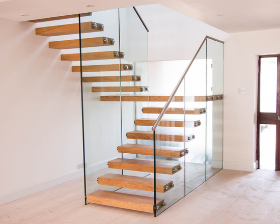 Floating staircase with thick treads and a glass balustrade 